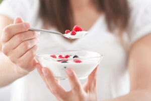 Young woman eating yogurt